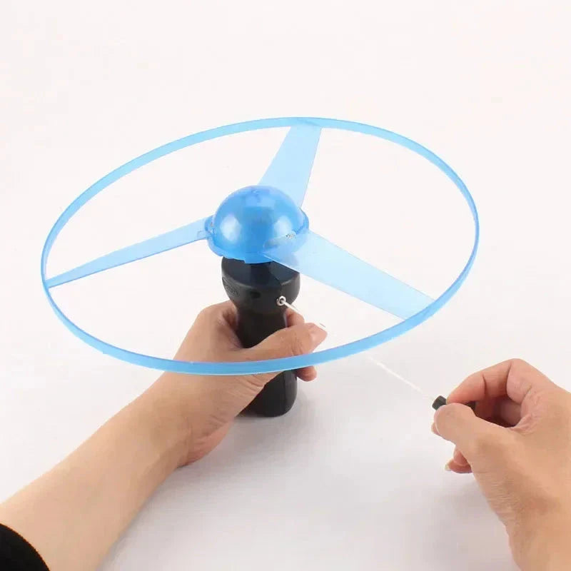 Pull Wire Glow UFO – Spinning LED Flyer Toy for Kids Outdoor Fun